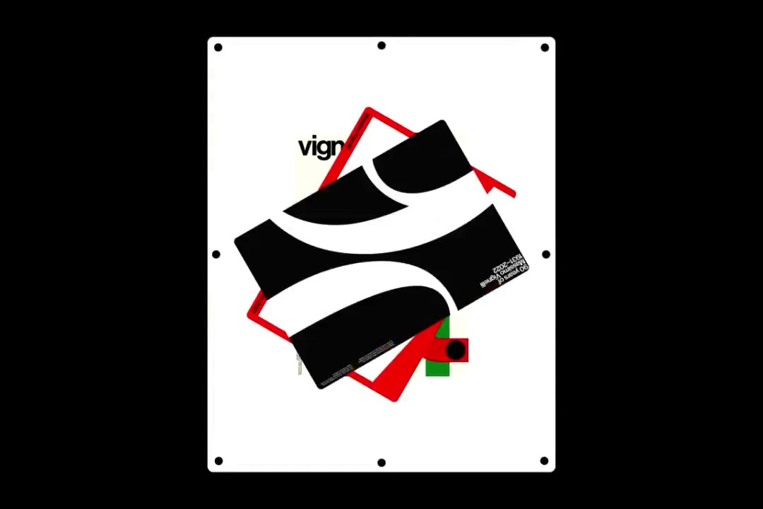 White plate on black with Vignelli posters layered and red zigzag